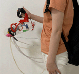 a men holding a weight simulation device and a Oculus controller